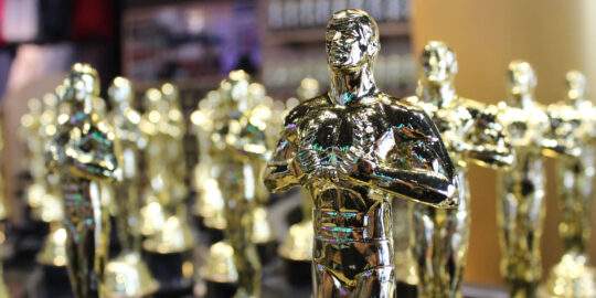 Golden Award statues of men - national recycling awards healthcare waste