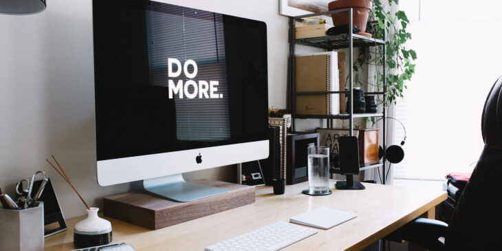 Home office with Mac displaying 'Do More' - NHS South England Waste Management