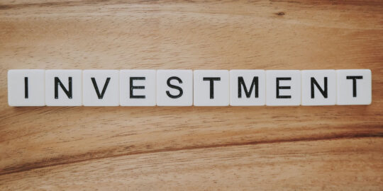 Investment spelt in scrabble tiles - investment nhs waste disposal
