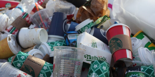 Pile of disposable coffee cups and cans - GP waste management