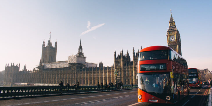 Double decker bus crossing London Bridge with Big Ben and Parliament in the background