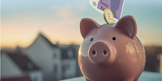 Money savings going into piggy bank